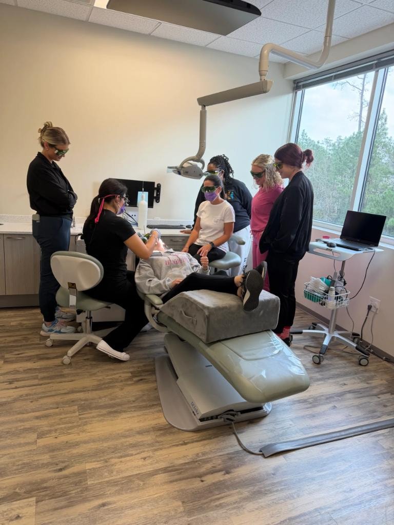 Dental team participating in group laser certification training session